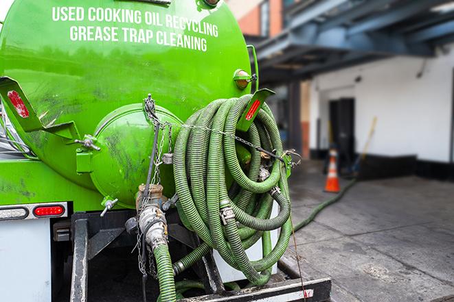 pumping out excess grease and waste from a restaurant's trap in Brightwaters, NY